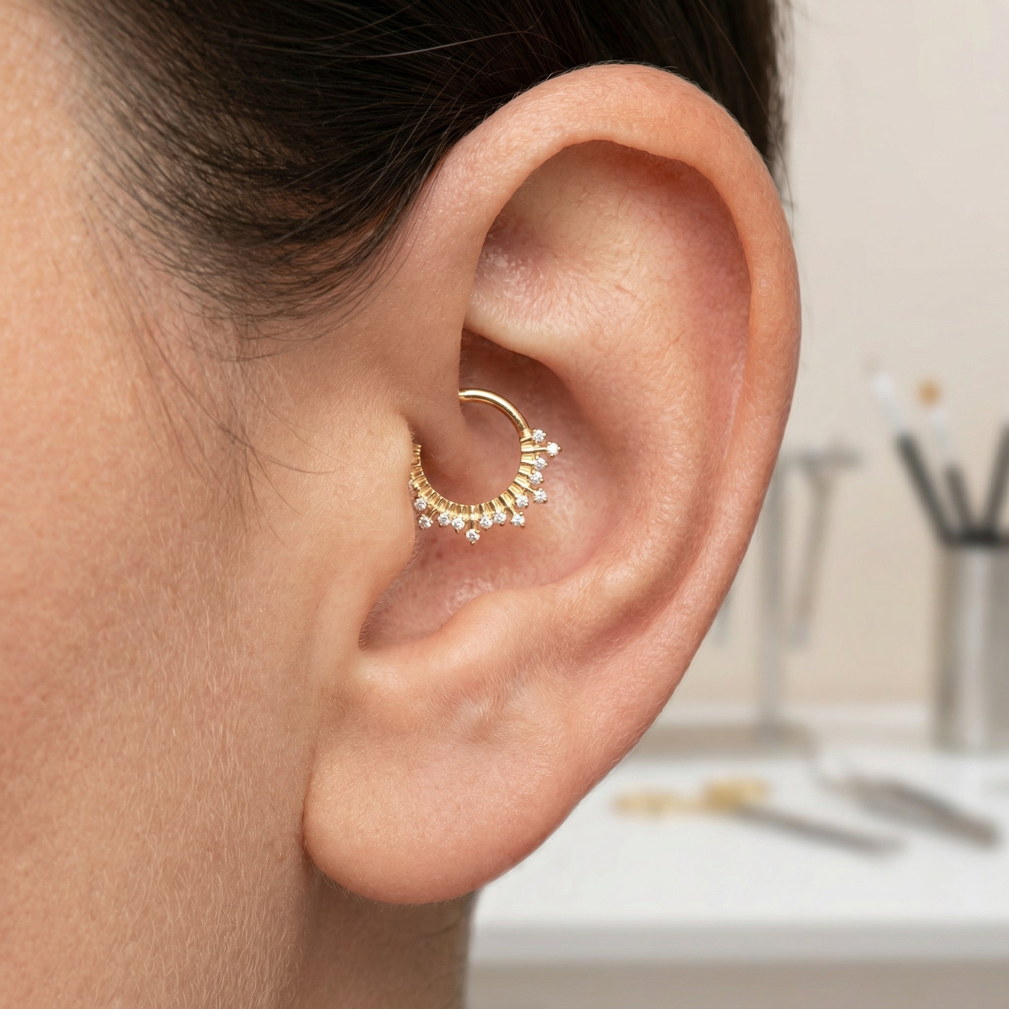 Gold zircon crown hinged clicker hoop styled beautifully inside a model's inner