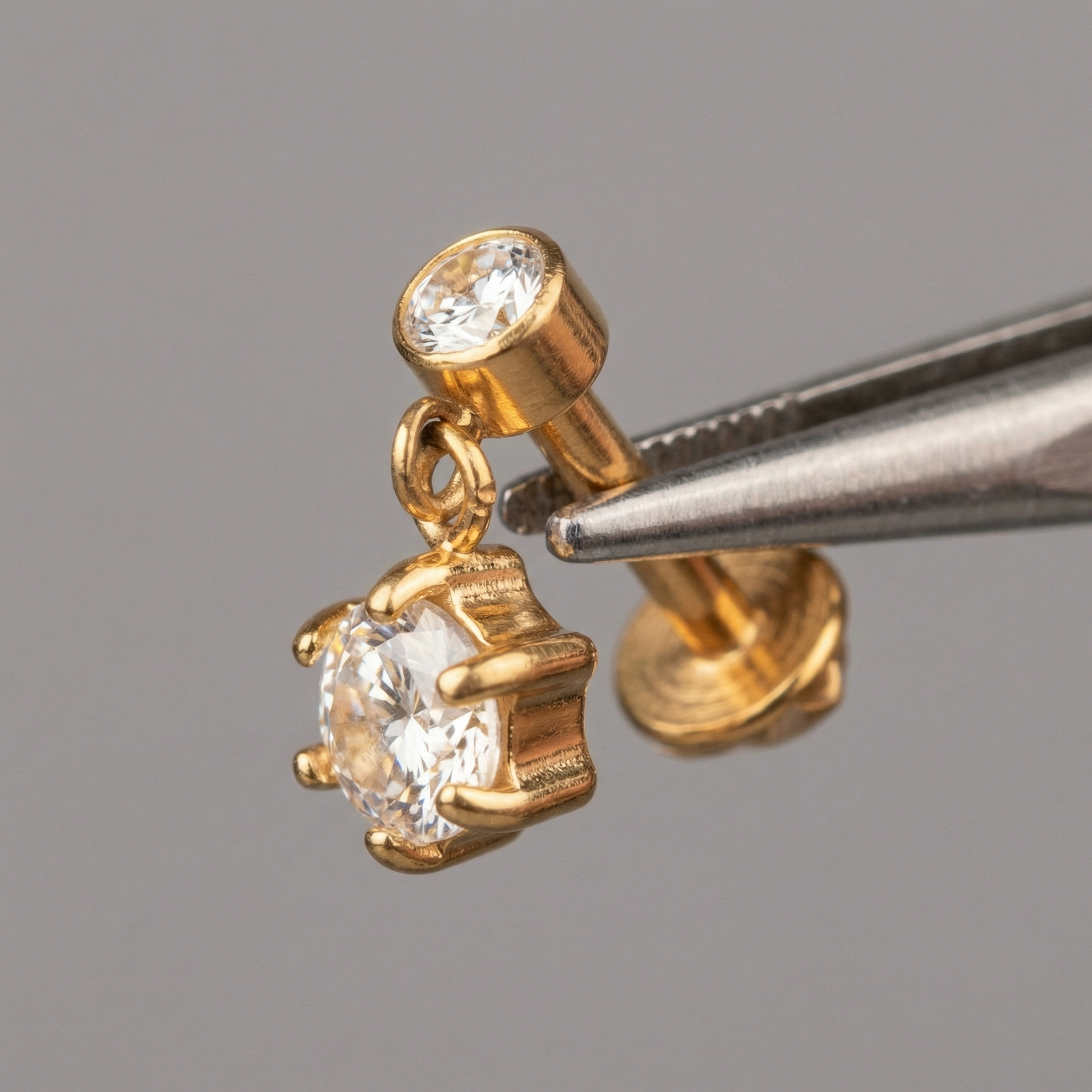 Zircon Hidden Helix Piercing - Precision tweezers holding a