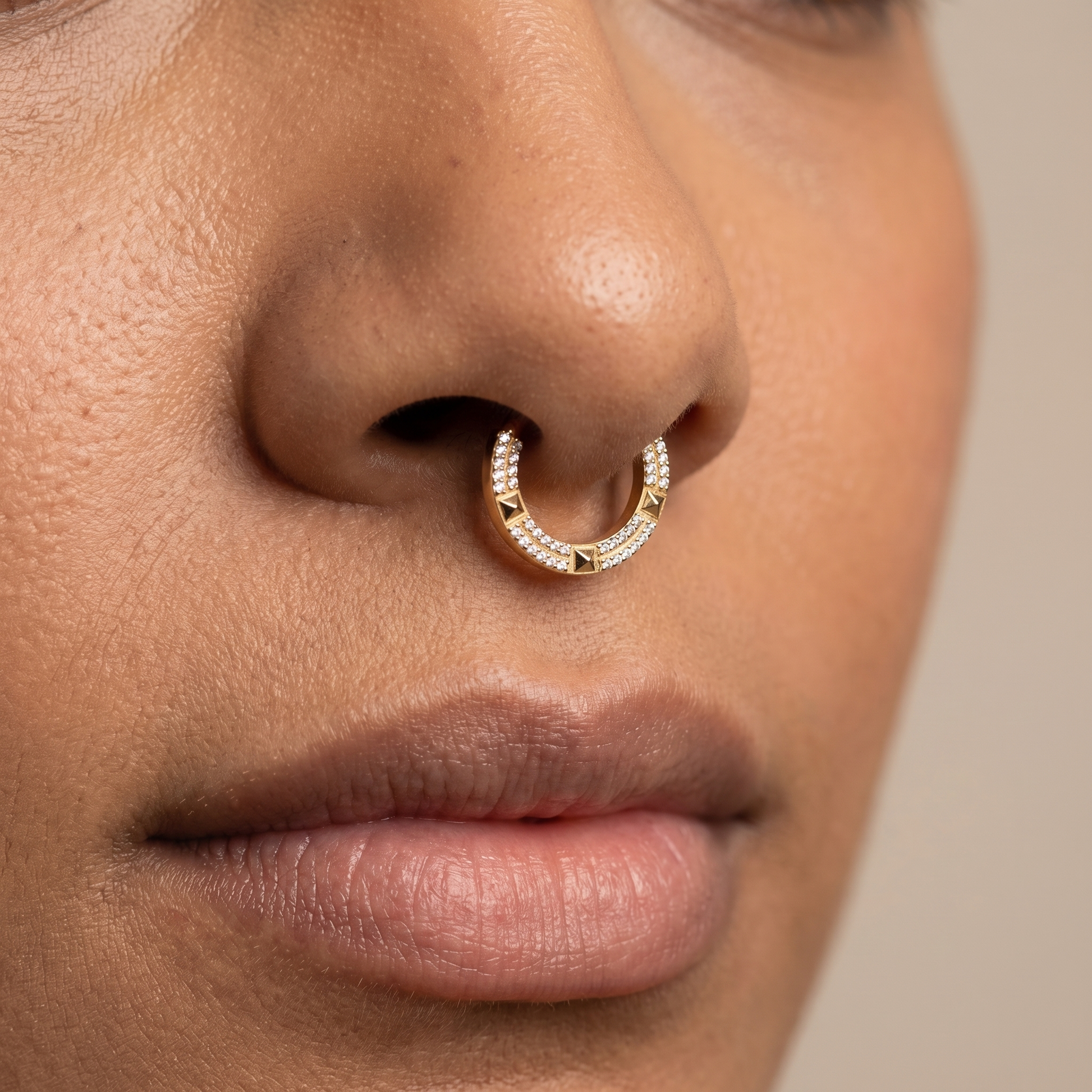 Close-up of a silver geometric zircon clicker worn cleanly in a model's