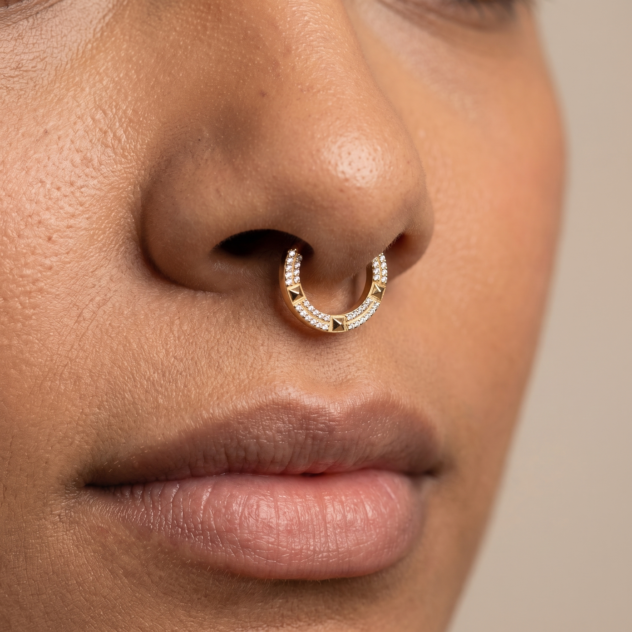 Close-up of a silver geometric zircon clicker worn cleanly in a model's