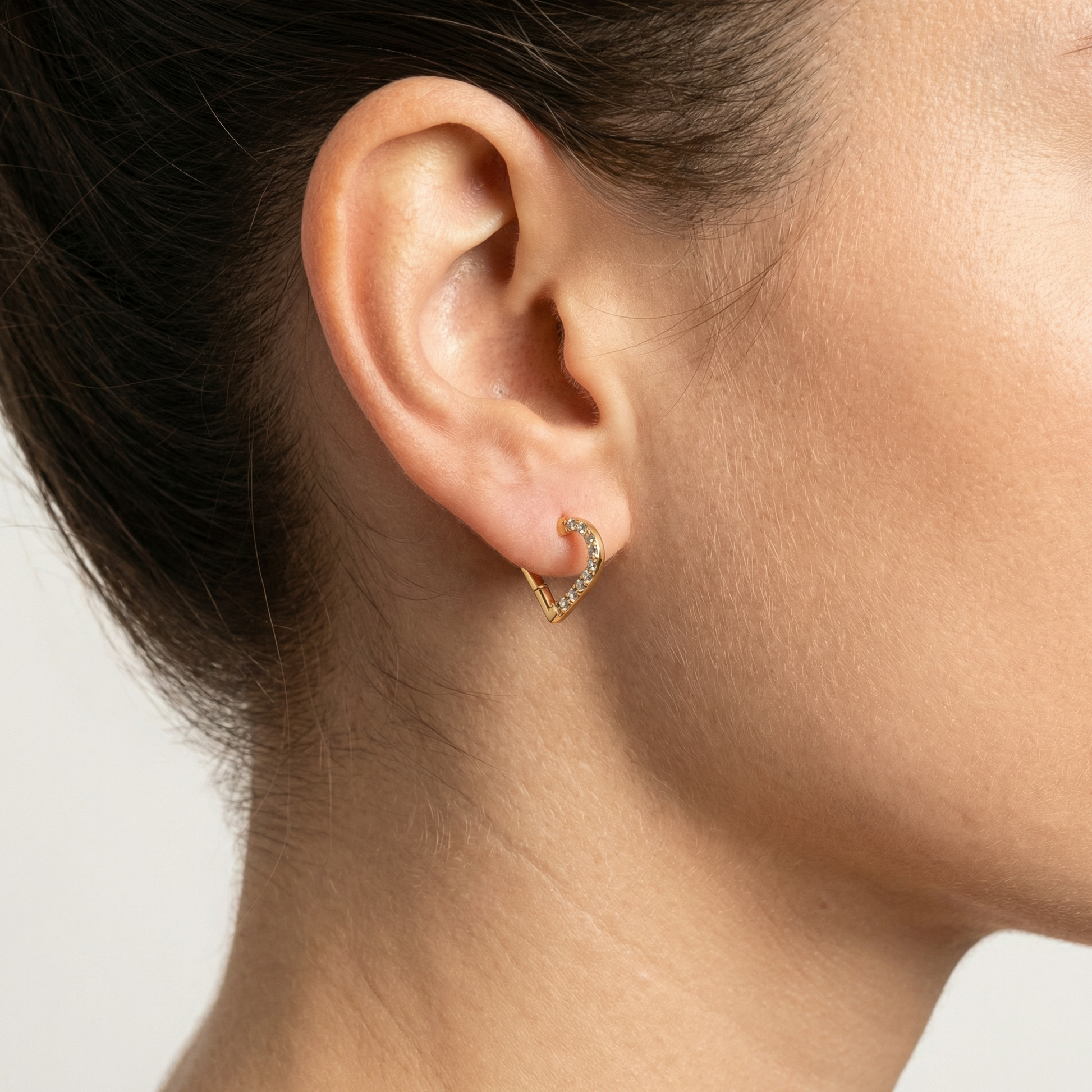 Side view of standard piercing using a heart ring.