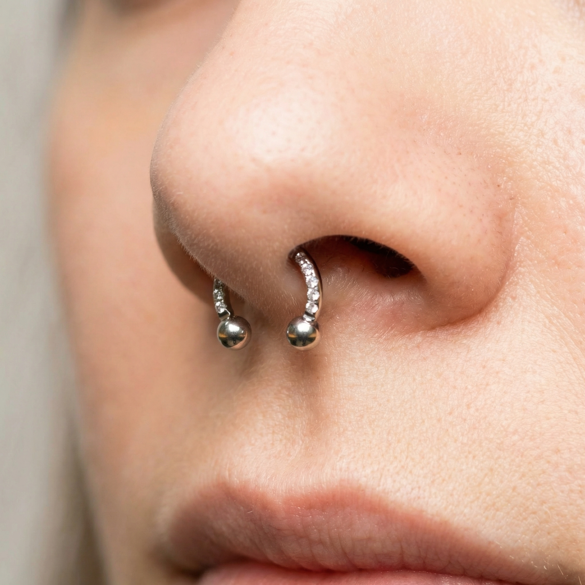 Silver zircon pave hinged horseshoe clicker ring styled perfectly as a piercing.